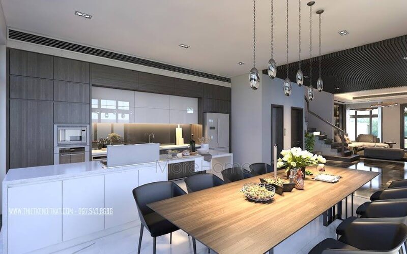 Thiết kế nội thất phòng ăn liền bếp hiện đại, sang trọng từ tủ bếp đảo kết hợp đá ốp cao cấp cùng bộ bàn ghế ăn gỗ nguyên tấm độc đáo. Thiết kế nội thất phòng bếp ăn biệt thự